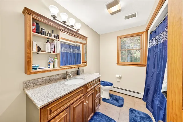 a bathroom with a sink a vanity and a large mirror