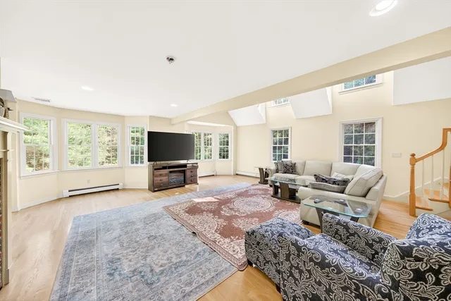 a living room with furniture large windows and a flat screen tv