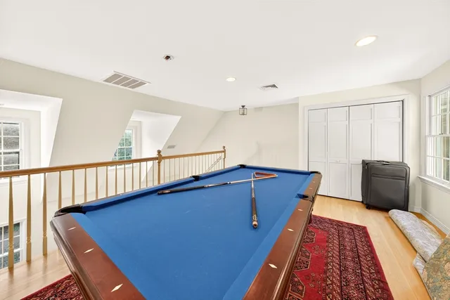 a balcony with wooden floor and furniture