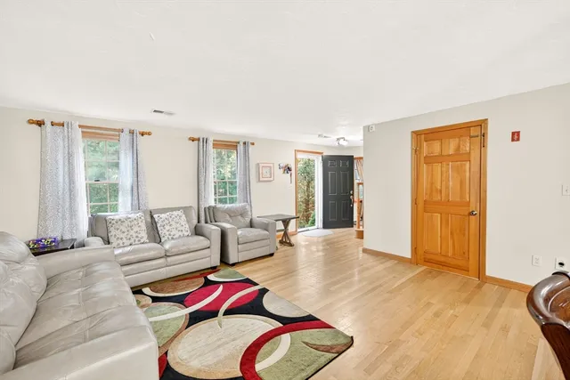 a living room with furniture fireplace and dining table
