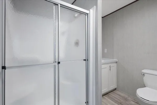 a bathroom with a shower and a toilet
