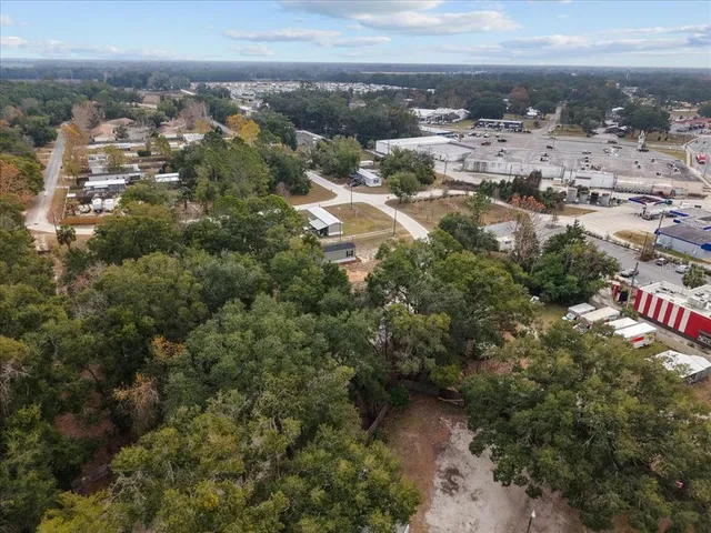 an aerial view of a house with yard swimming pool and lake view