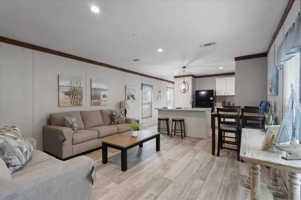 a living room with furniture and kitchen view