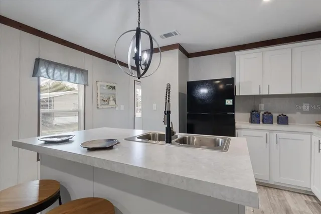 a kitchen with stainless steel appliances a counter space a sink and cabinets