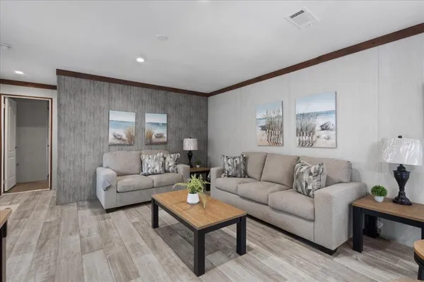 a living room with furniture and wooden floor