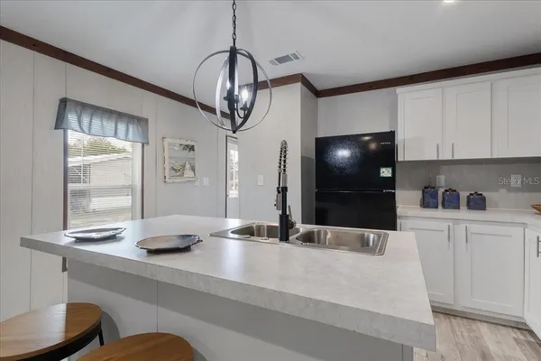 a kitchen with stainless steel appliances a counter space a sink and cabinets