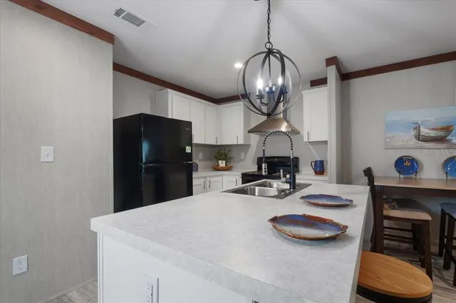 a kitchen with stainless steel appliances granite countertop a sink a stove and a refrigerator