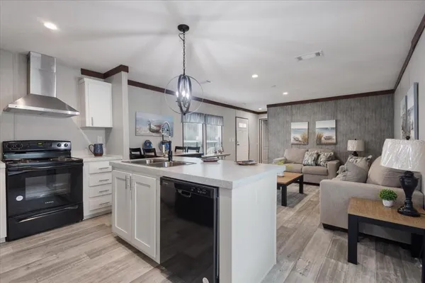 a kitchen with cabinets a sink and appliances
