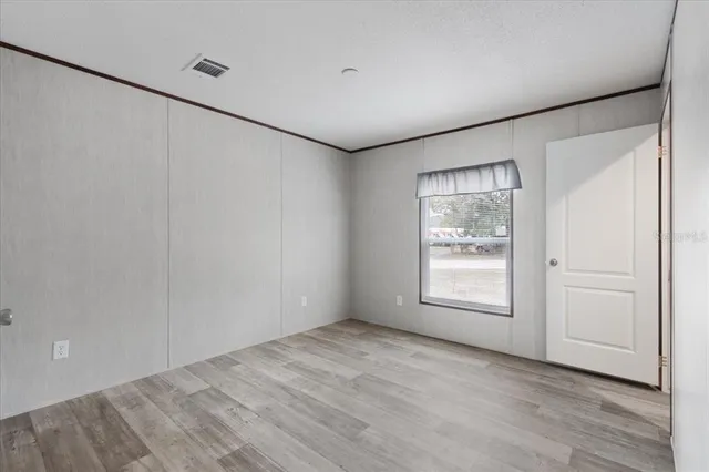 an empty room with windows and closet