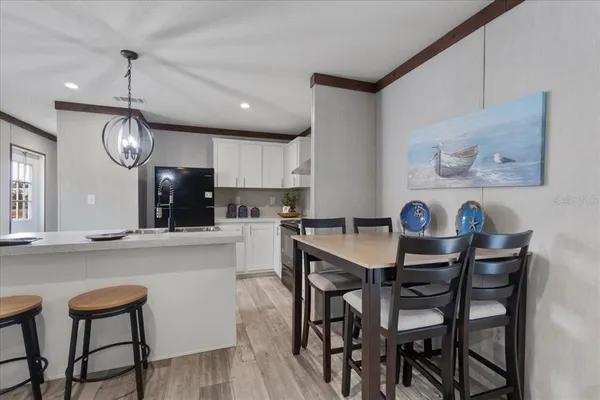 a view of kitchen with cabinets table and chairs