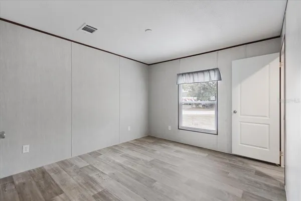 an empty room with windows and closet