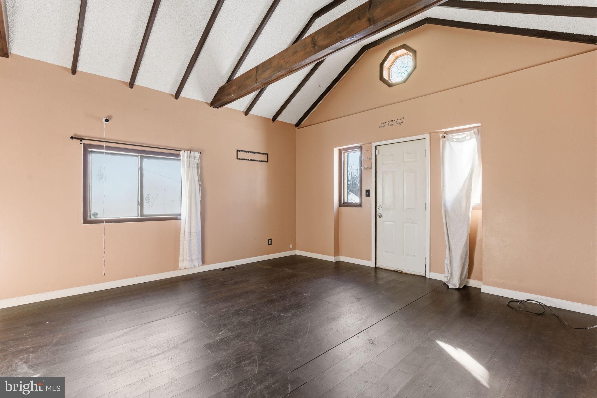 1057 Bridge Road Bensalem, PA 19020 - Photo 16 of 37 an empty room with wooden floor and windows