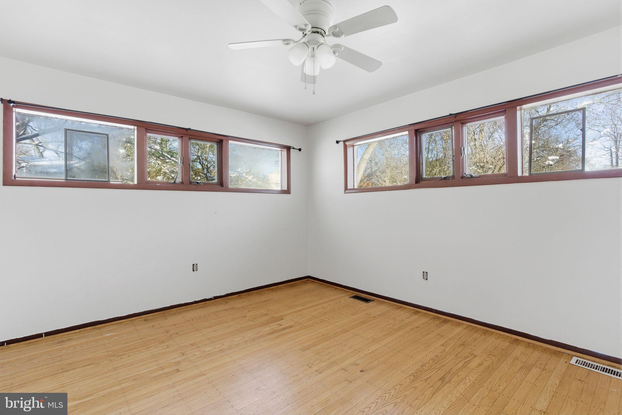 1057 Bridge Road Bensalem, PA 19020 - Photo 23 of 37 a view of an empty room with a window and a ceiling fan