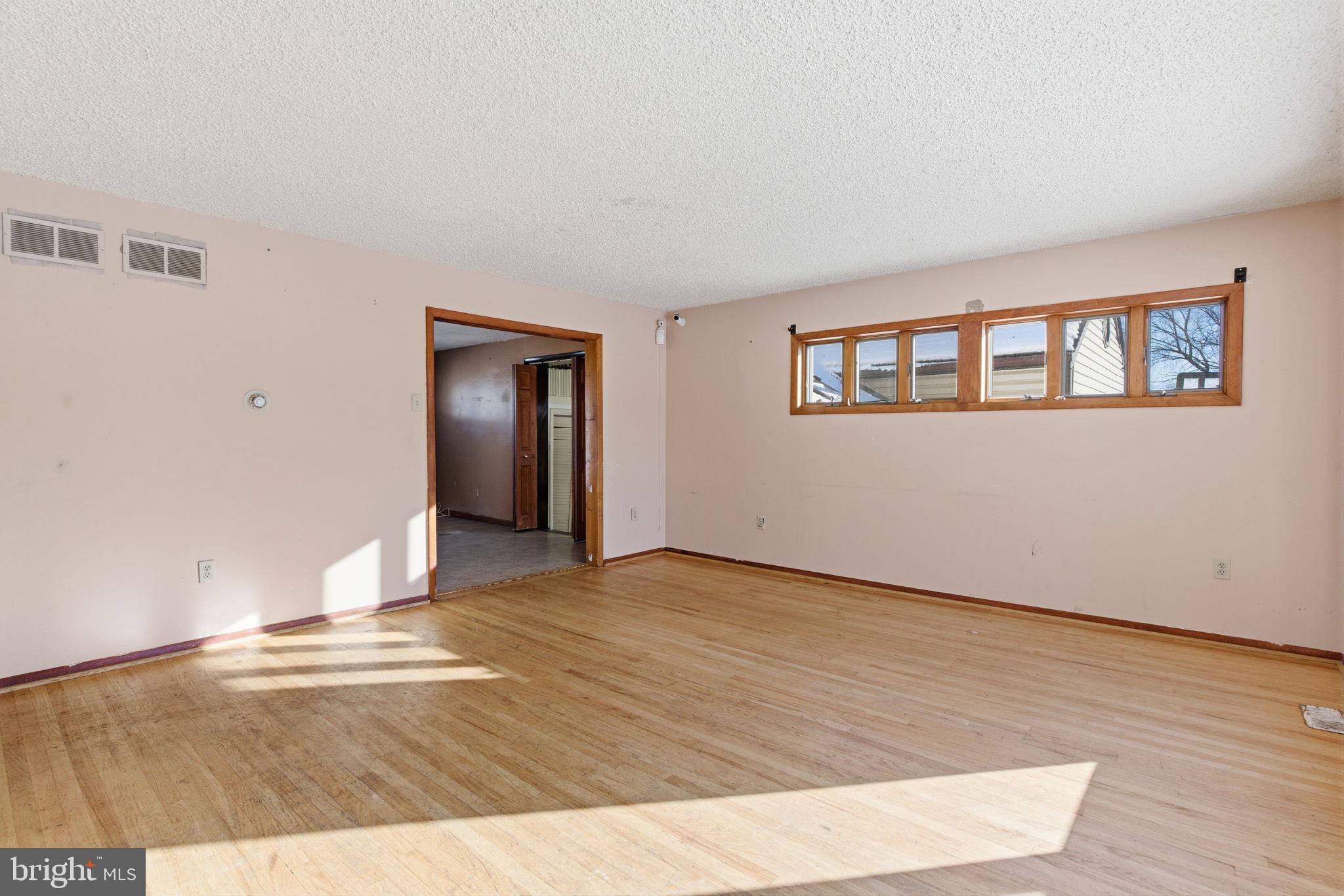 1057 Bridge Road Bensalem, PA 19020 - Photo 3 of 37 a view of an empty room with wooden floor and a window