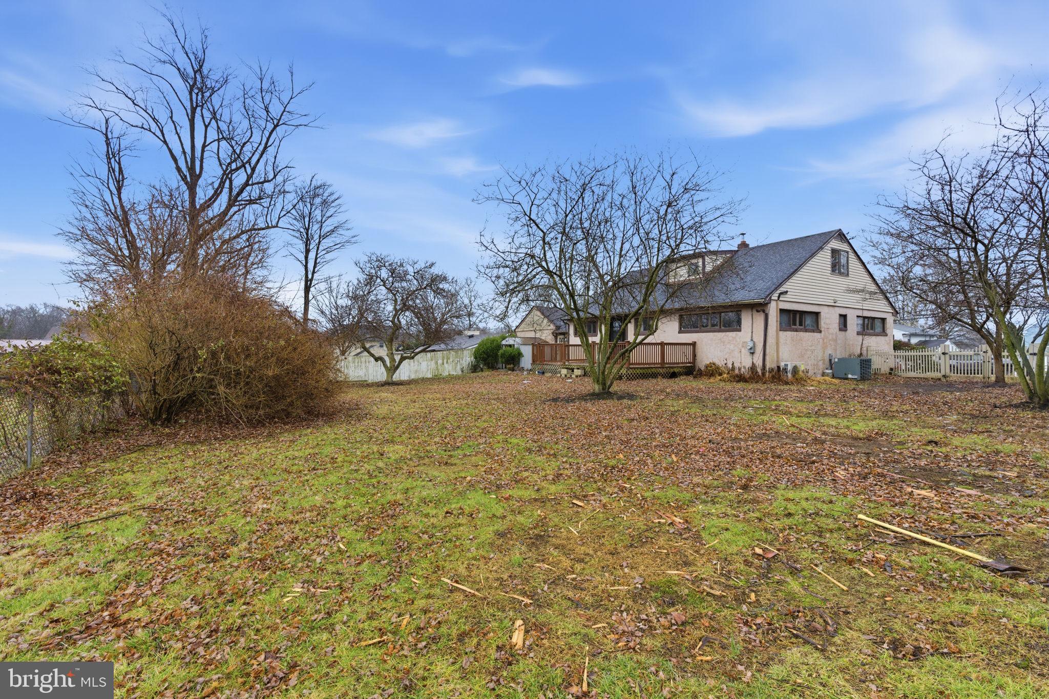 1057 Bridge Road Bensalem, PA 19020 - Photo 34 of 37 a front view of house with yard and trees in the background
