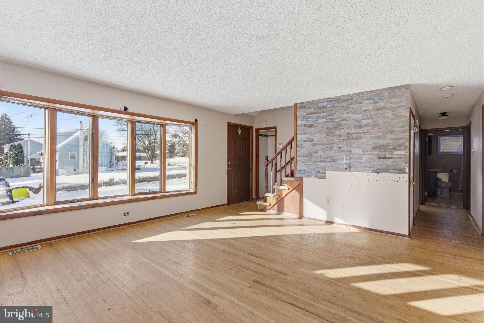 1057 Bridge Road Bensalem, PA 19020 - Photo 5 of 37 a view of empty room with wooden floor and fan