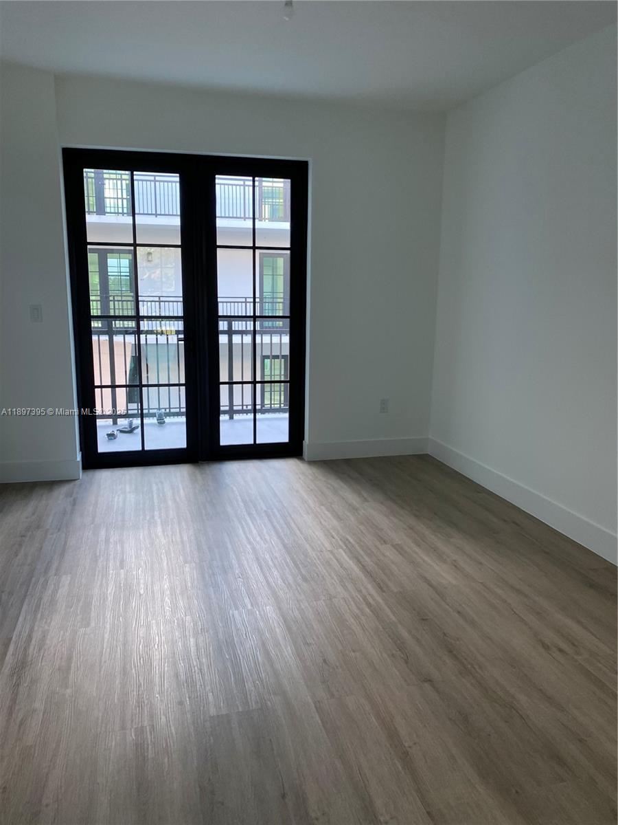4100 Southwest 64th Avenue, Unit 314 Davie, FL 33314 - Photo 11 of 17 wooden floor and white walls