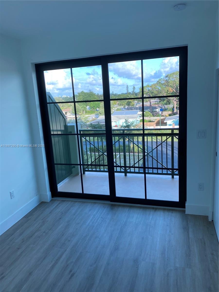 4100 Southwest 64th Avenue, Unit 314 Davie, FL 33314 - Photo 12 of 17 a view of a room with wooden floor and windows