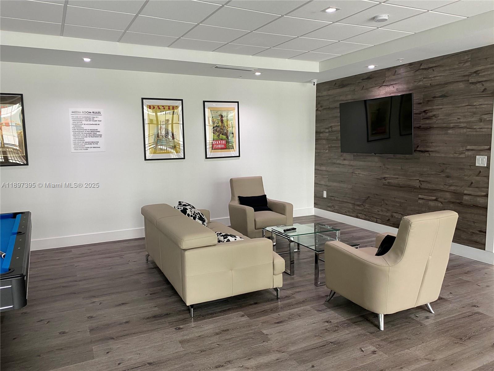 4100 Southwest 64th Avenue, Unit 314 Davie, FL 33314 - Photo 17 of 17 a living room with furniture and a flat screen tv