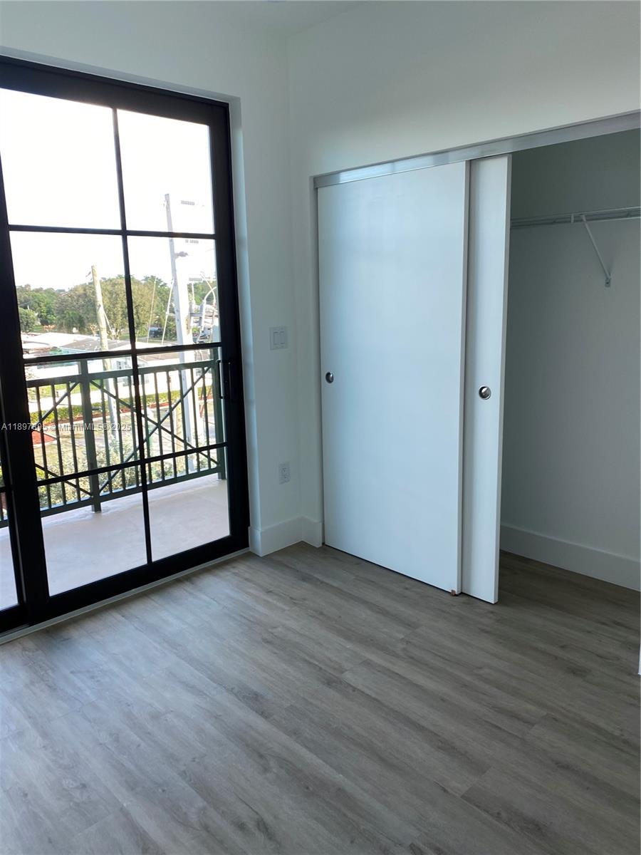 4100 Southwest 64th Avenue, Unit 314 Davie, FL 33314 - Photo 4 of 17 a view of a room with wooden floor and door