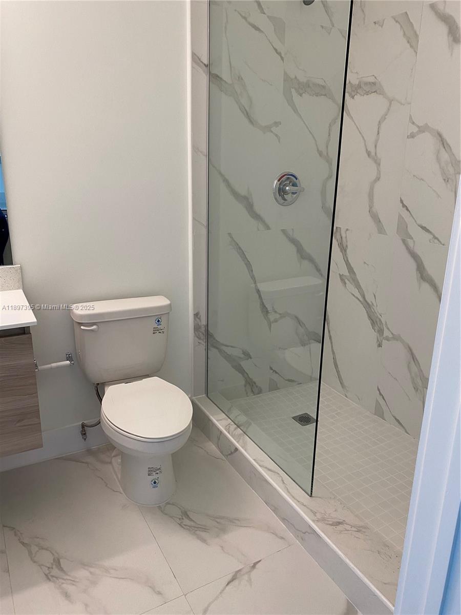 4100 Southwest 64th Avenue, Unit 314 Davie, FL 33314 - Photo 7 of 17 a bathroom with a toilet and shower