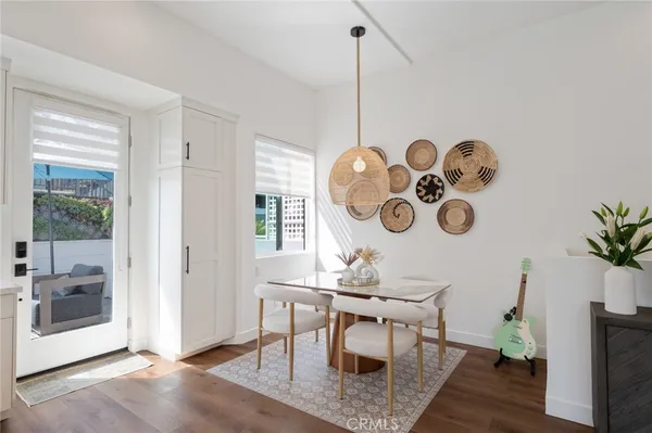 a view of a dining room with furniture and chandelier