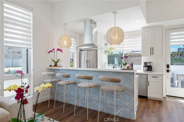 a very nice looking dining room with wooden floor and a large window
