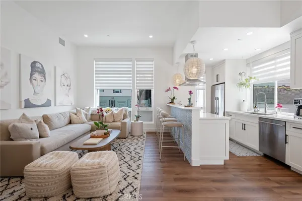 a living room with fireplace furniture and a large window