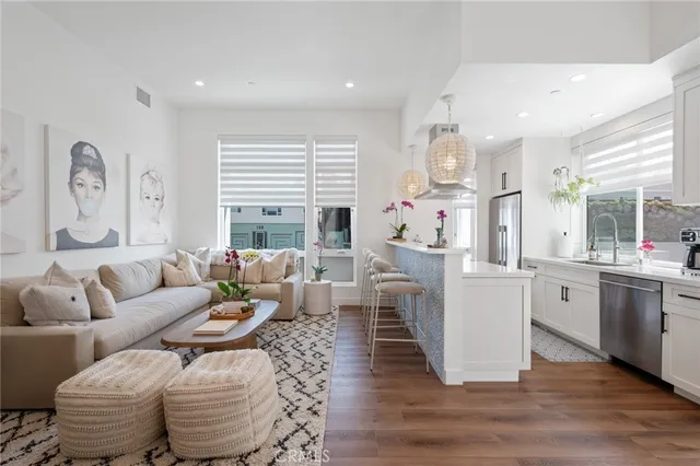 a living room with fireplace furniture and a large window