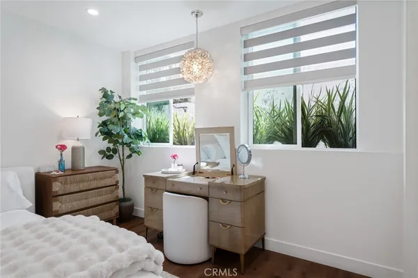 a living room with furniture a chandelier and a window