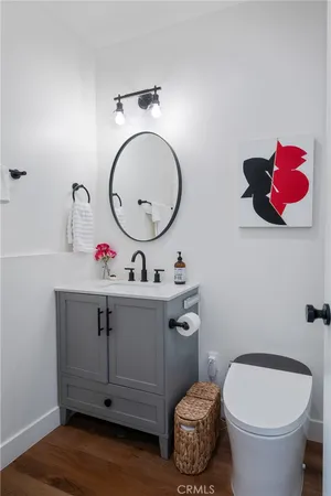 a bathroom with a toilet a sink and mirror