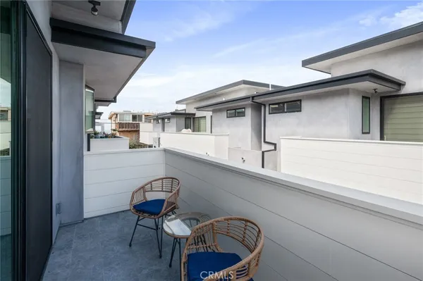 a view of a chairs and table in a balcony