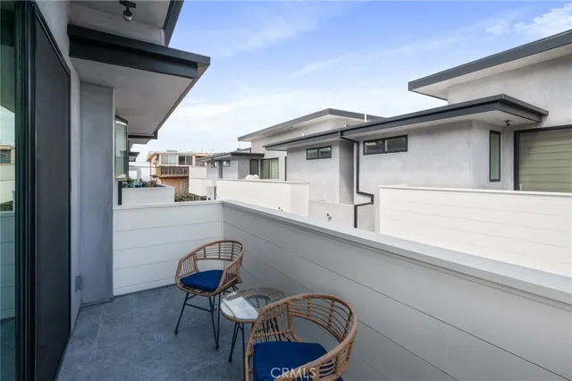 a view of a chairs and table in a balcony