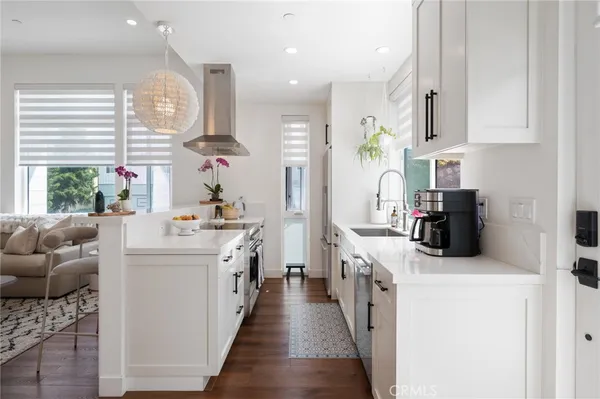 a kitchen with cabinets a sink and appliances