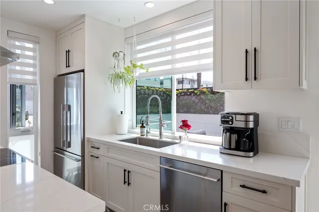 a kitchen with stainless steel appliances a sink stove and refrigerator