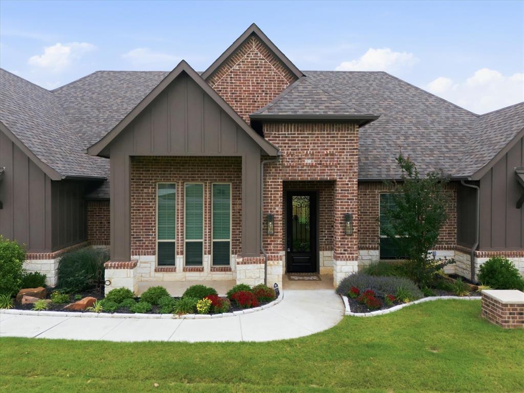 150 Quail Ridge Decatur, TX 76234 - Photo 4 of 32 a front view of a house with a yard