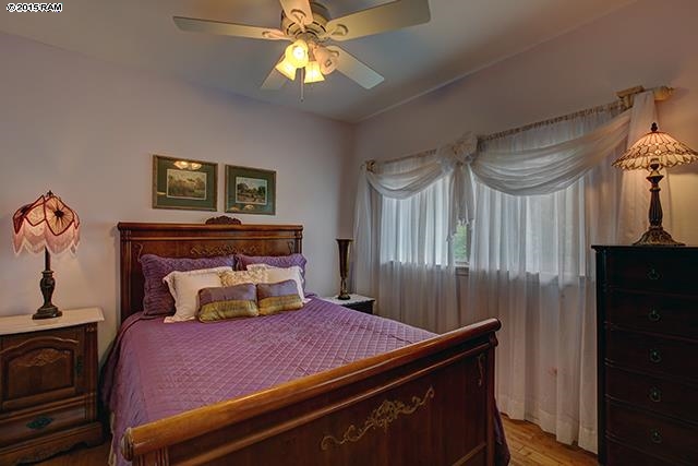 104 Cooke Road Kula, HI 96790 - Photo 12 of 22 a bedroom with a bed and a chandelier