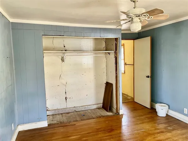 a view of a room with wooden floor and cabinet