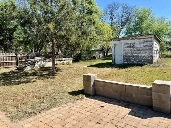 a view of a backyard with sitting area