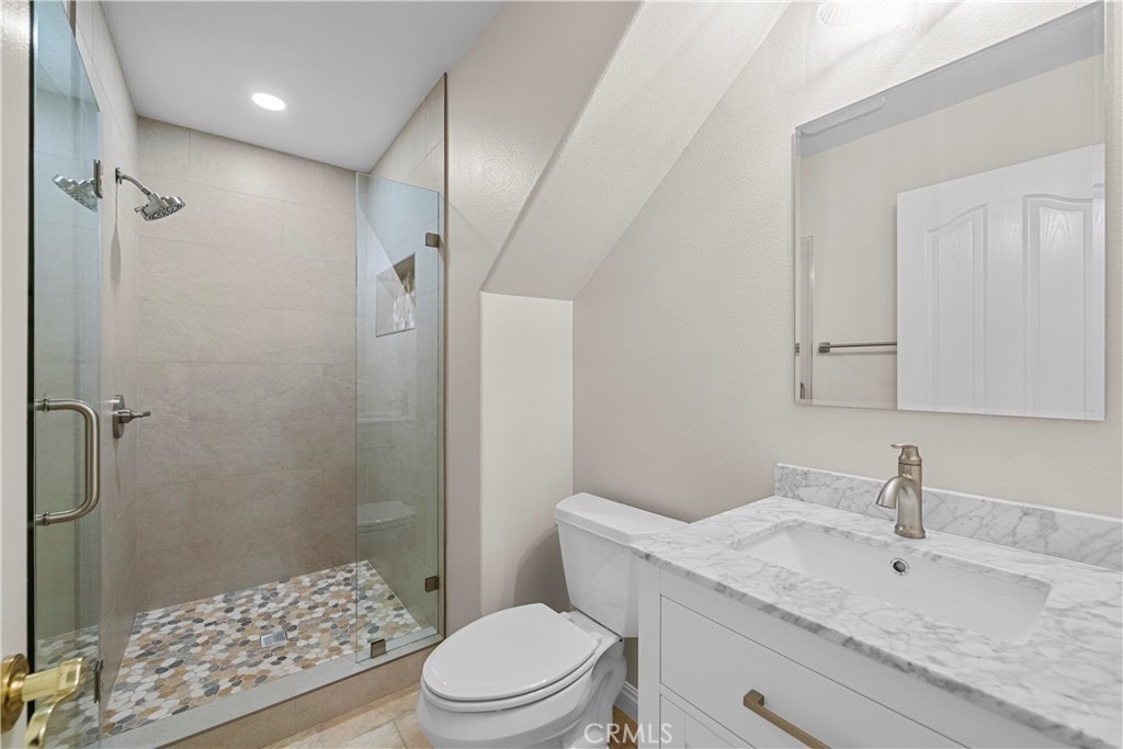 25512 Wilde Avenue Stevenson Ranch, CA 91381 - Photo 14 of 53 a bathroom with a sink a toilet and shower