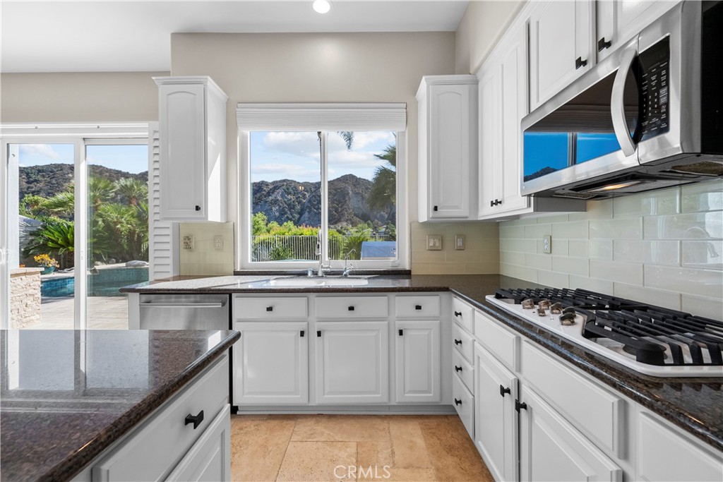 25512 Wilde Avenue Stevenson Ranch, CA 91381 - Photo 20 of 53 a kitchen with stainless steel appliances granite countertop a sink and a stove
