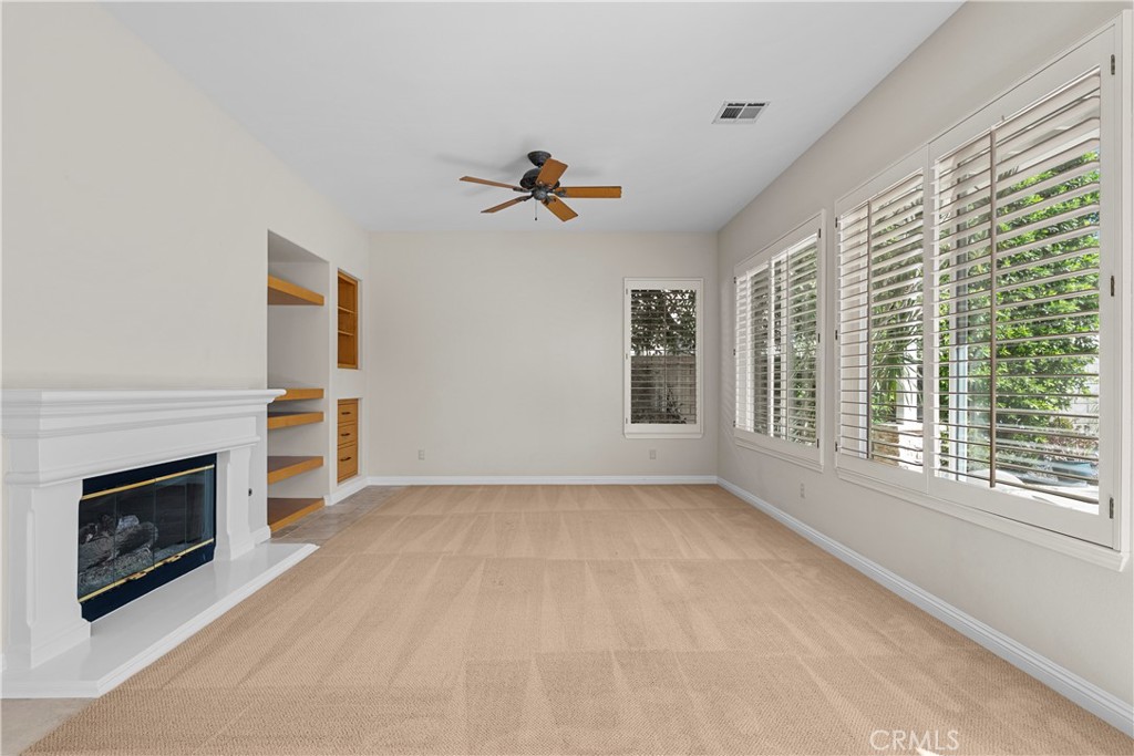 25512 Wilde Avenue Stevenson Ranch, CA 91381 - Photo 30 of 53 an empty room with windows and fireplace