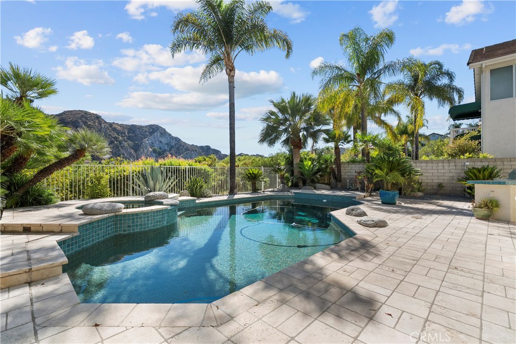 25512 Wilde Avenue Stevenson Ranch, CA 91381 - Photo 3 of 53 a view of a swimming pool and lounge chair