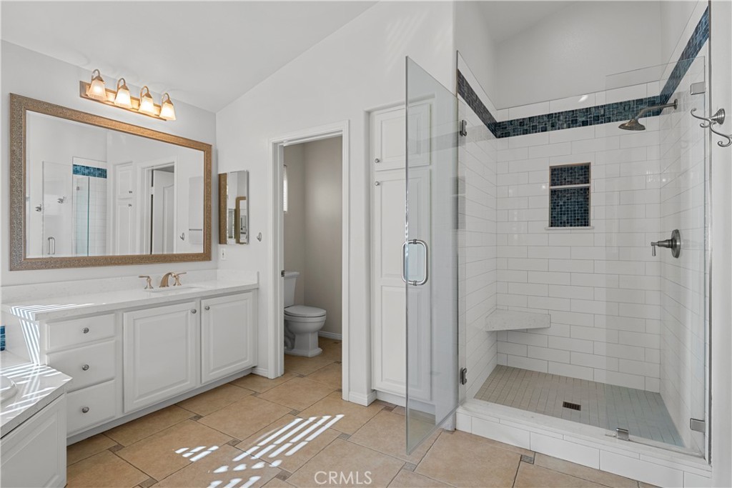 25512 Wilde Avenue Stevenson Ranch, CA 91381 - Photo 46 of 53 a spacious bathroom with a shower a sink and mirror