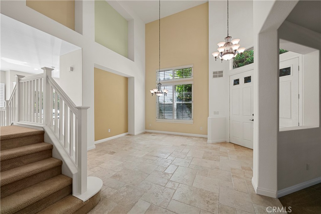 25512 Wilde Avenue Stevenson Ranch, CA 91381 - Photo 5 of 53 a view of an entryway with wooden floor and a chandelier