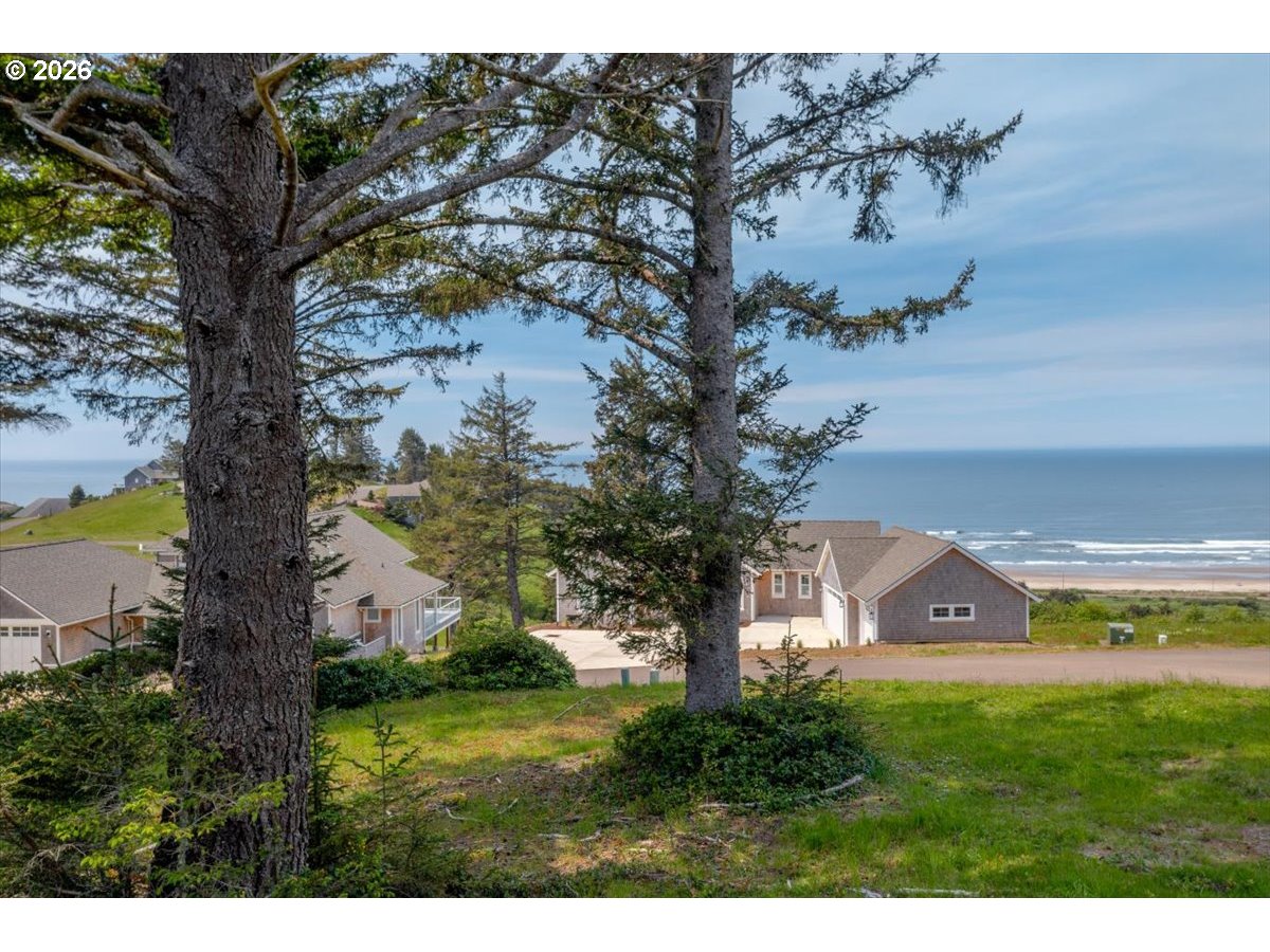 76 Megans View Point Cloverdale, OR 97112 - Photo 1 of 15 a view of a yard in front of a house with a large tree