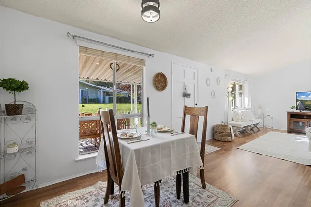 a view of a dining room with furniture window and wooden floor