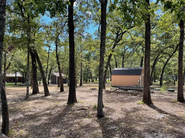 a street sign on a sidewalk next to a road