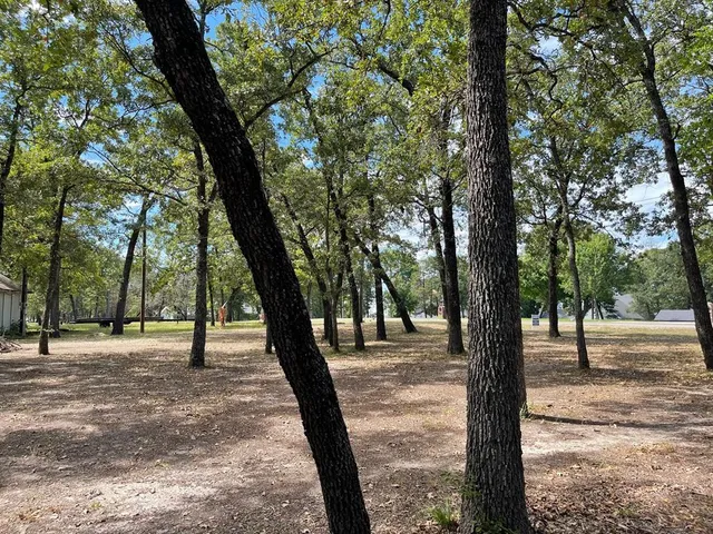 a sign board with yard in the back
