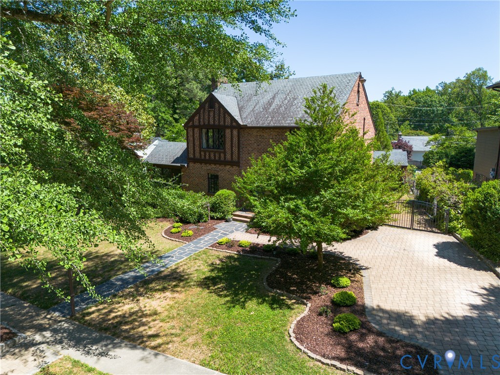 4814 Riverside Drive Richmond, VA 23225 - Photo 3 of 39 a view of a garden with plants and a bench